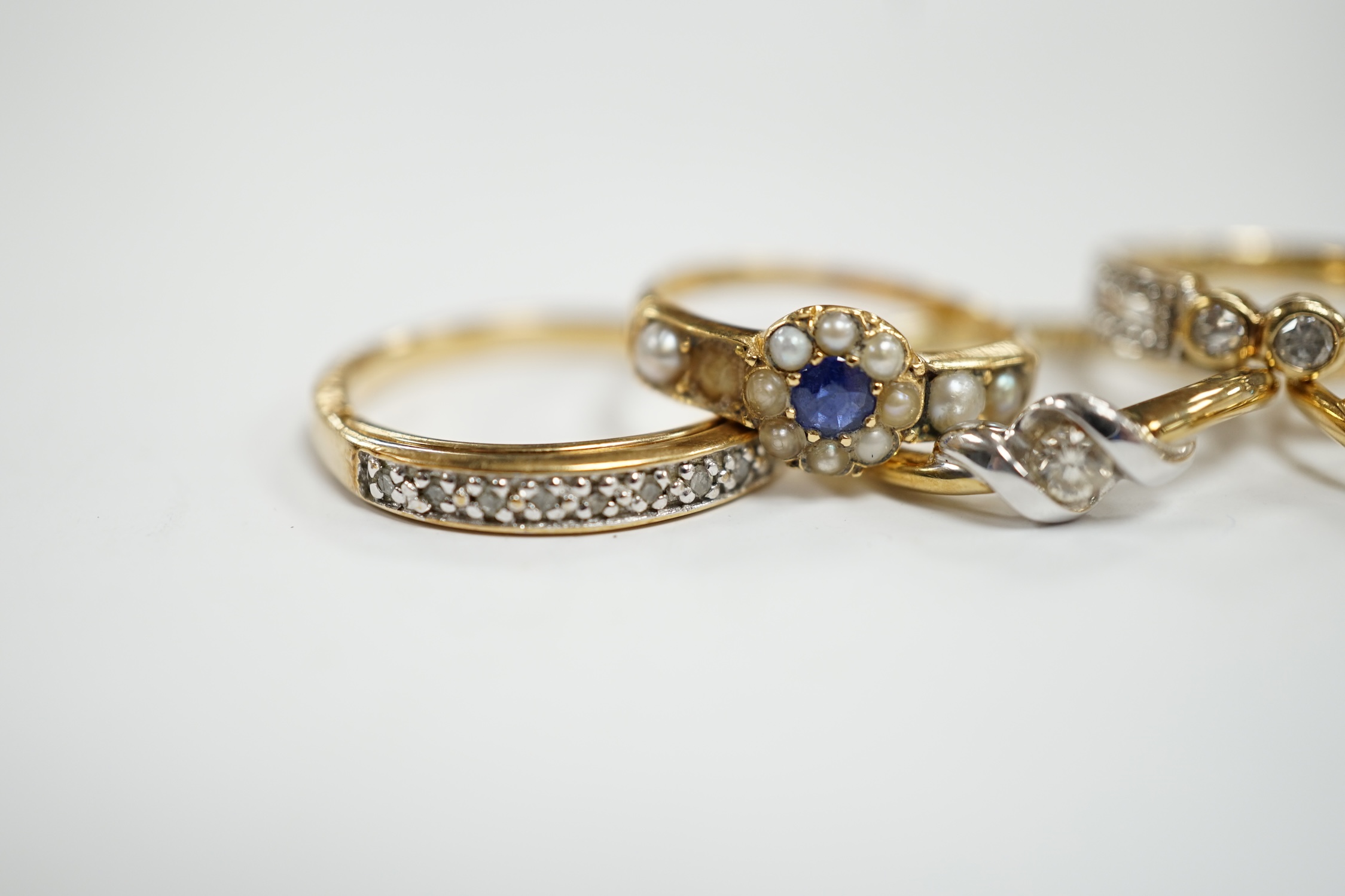 Three assorted modern 9ct gold and diamond set rings, gross 6.5 grams and two other yellow metal and gem set rings.